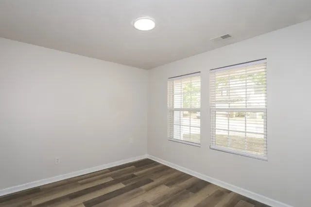 wooden floor in an empty room with a window