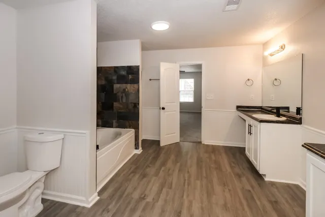 a bathroom with a bathtub and a toilet
