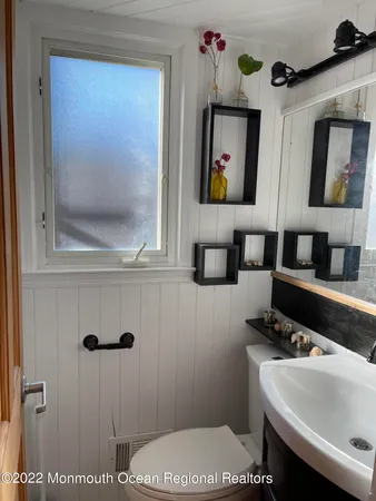 a bathroom with a shower a toilet and a window