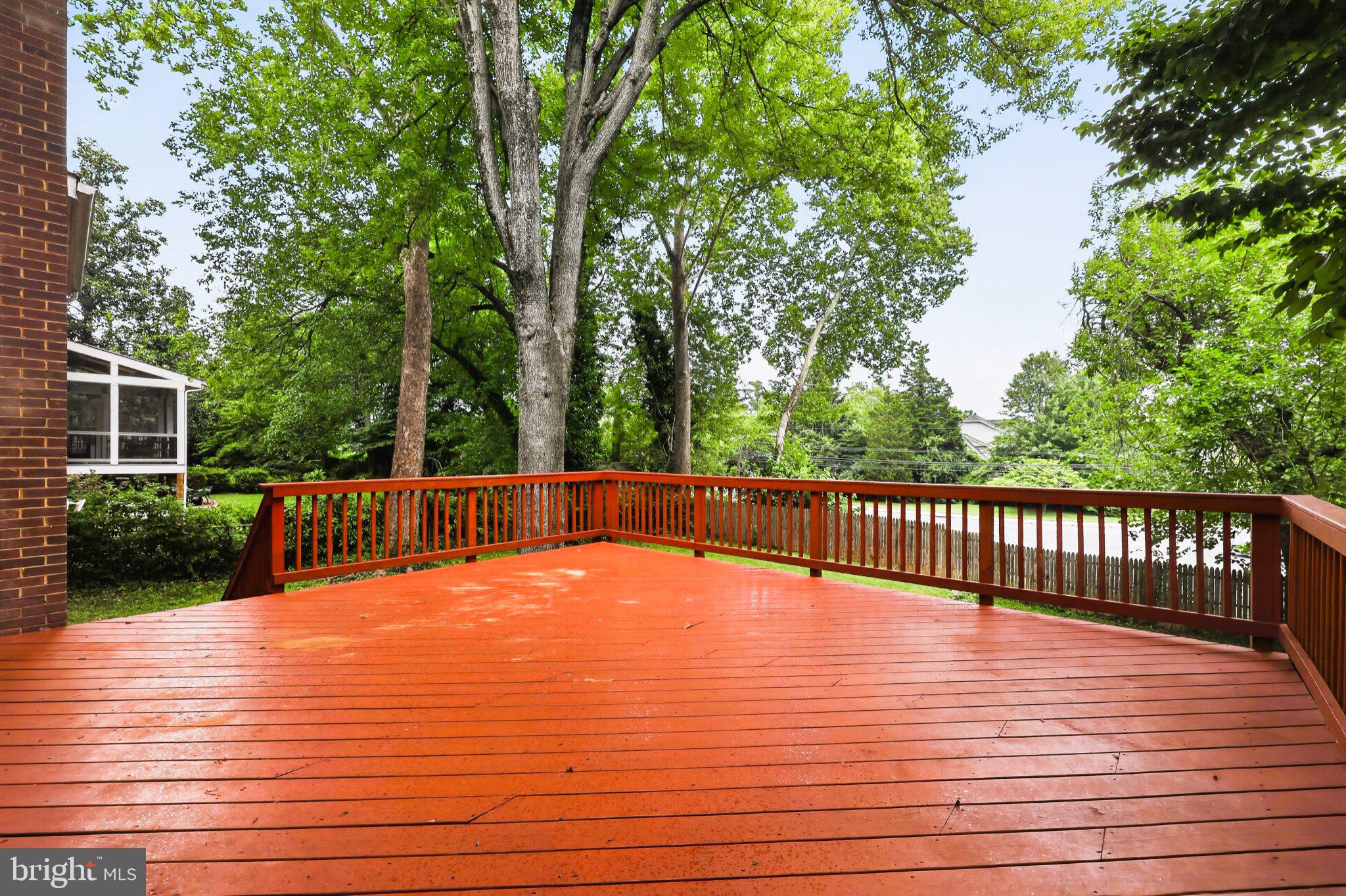 9901 Belhaven Road Bethesda, MD 20817 - Photo 5 of 32 Spacious deck surrounded by greenery.