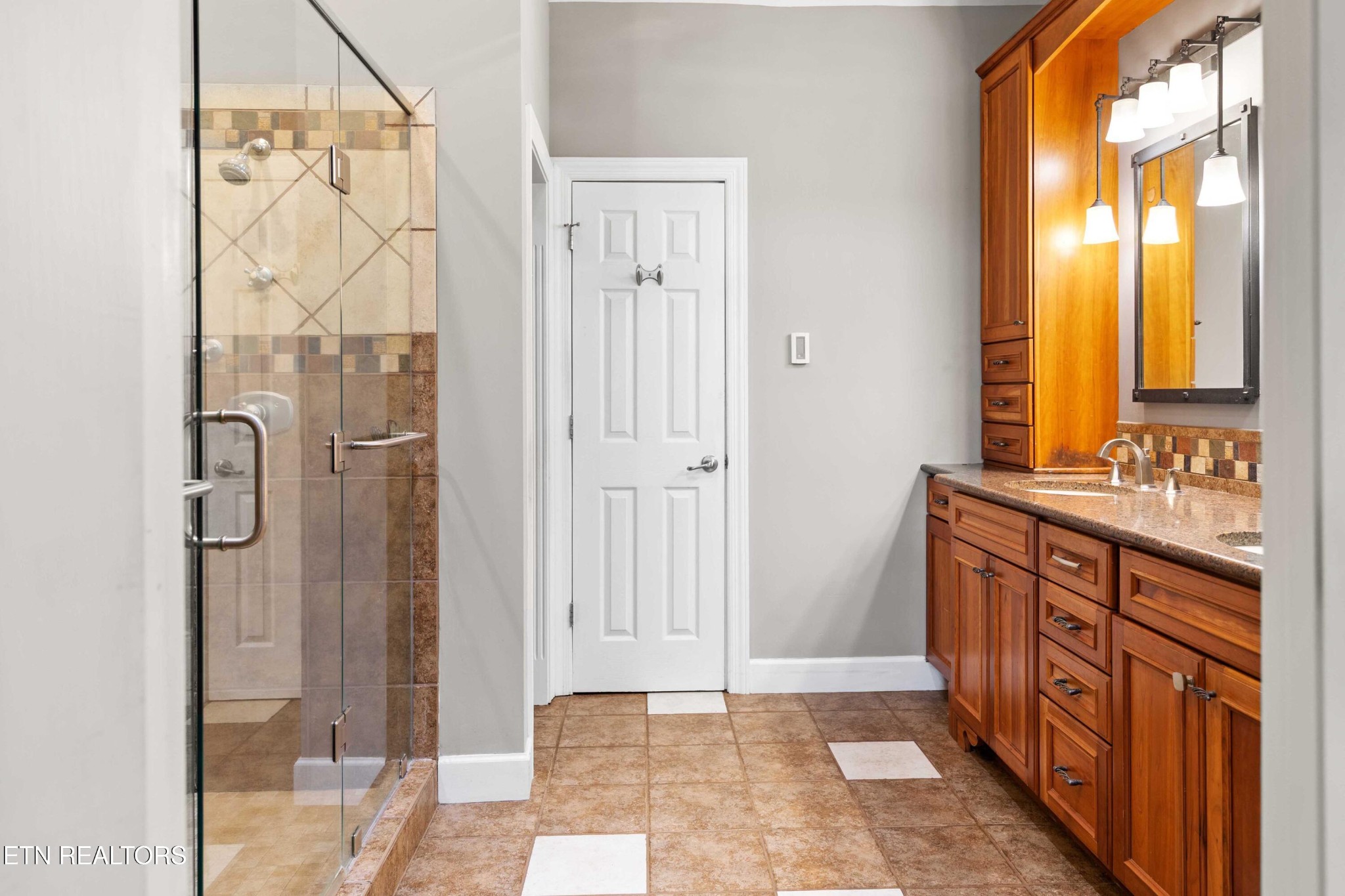 309 Bullrun Valley Drive Heiskell, TN 37754 - Photo 21 of 49 a bathroom with a double vanity sink a mirror and a shower