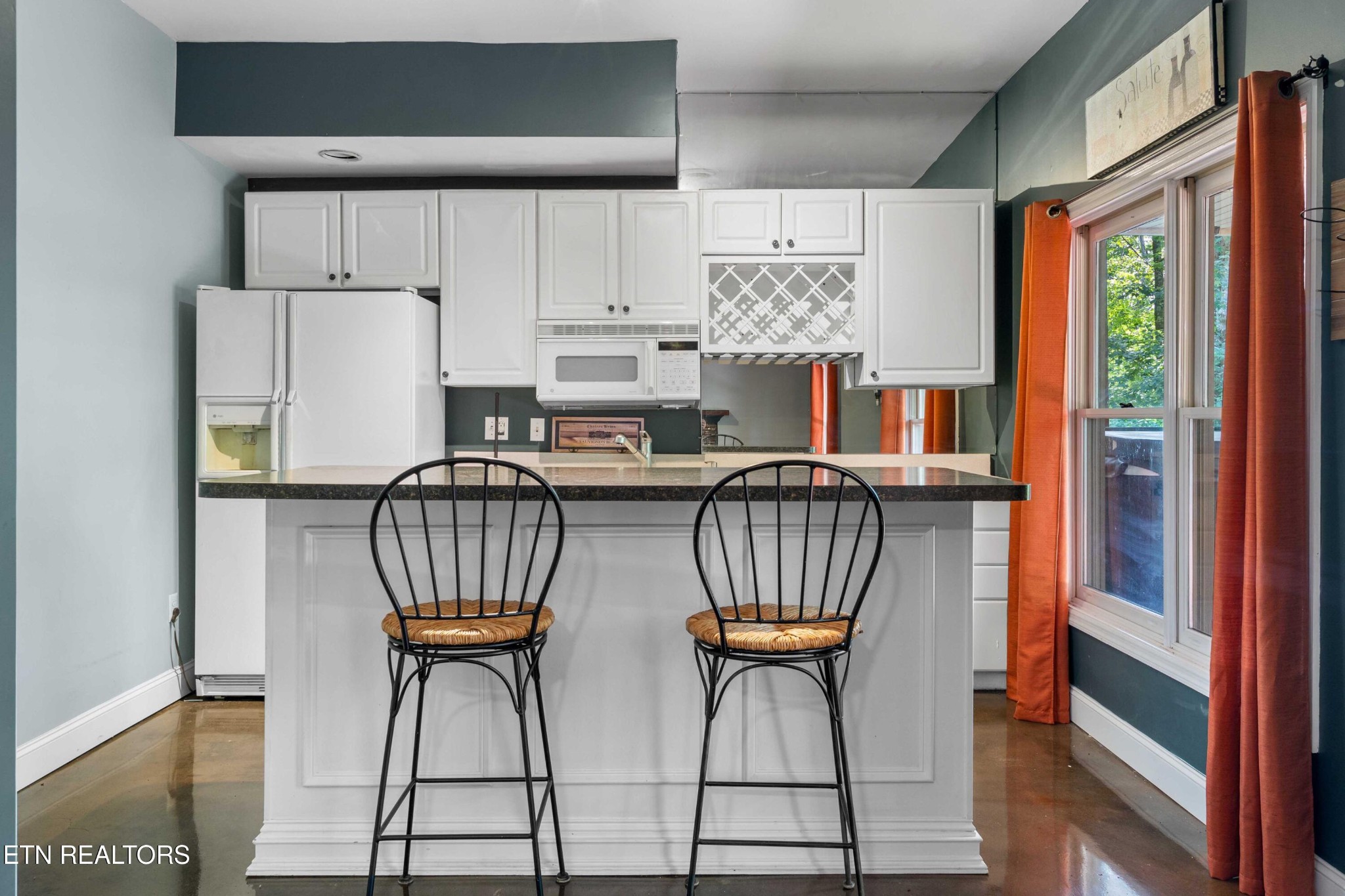 309 Bullrun Valley Drive Heiskell, TN 37754 - Photo 27 of 49 a kitchen with stainless steel appliances a table chairs and a refrigerator