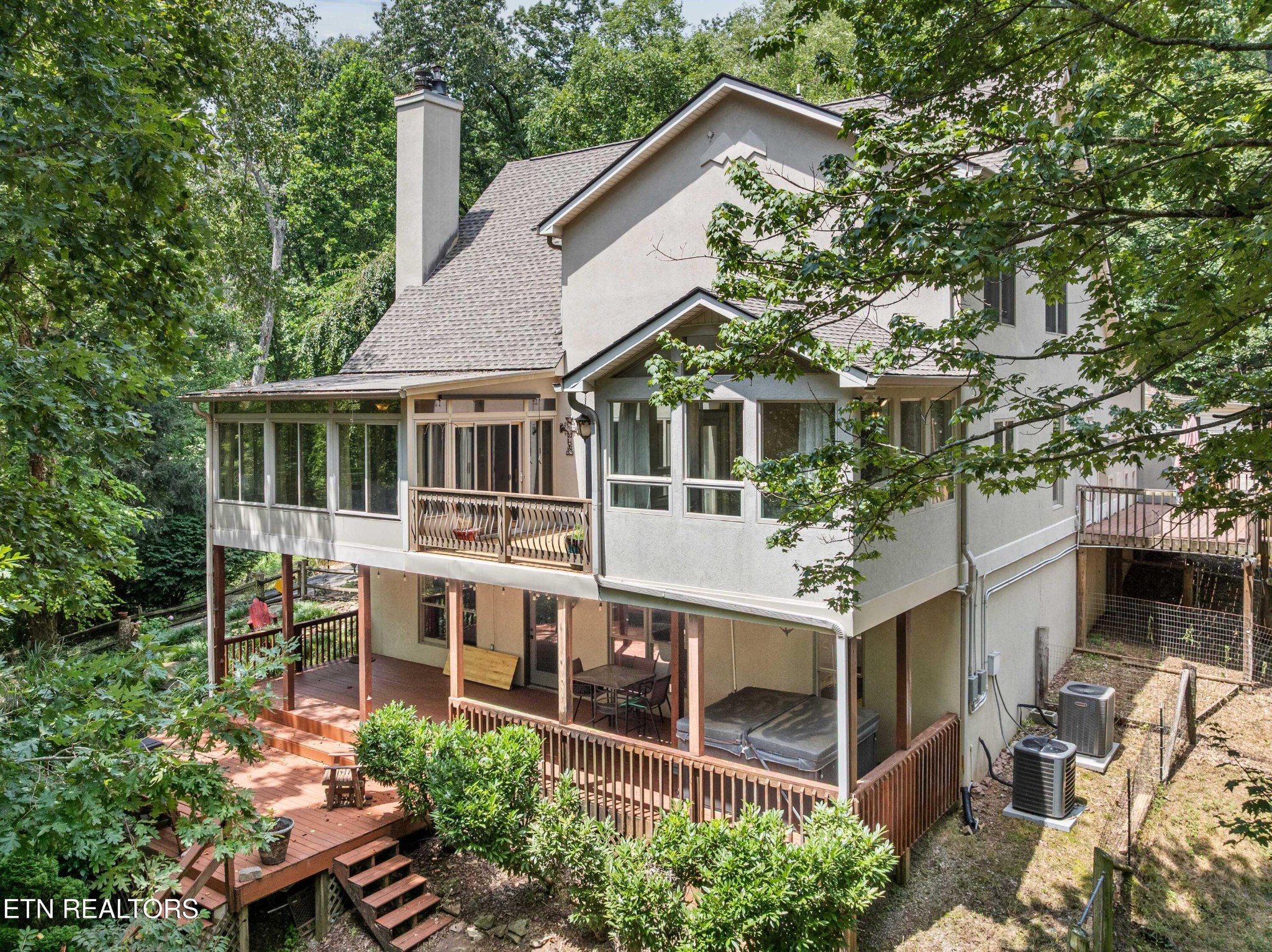 309 Bullrun Valley Drive Heiskell, TN 37754 - Photo 45 of 49 a view of a white house with large windows and a small yard