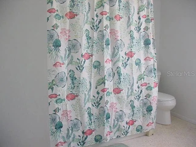 a bathroom with a sink and a curtain