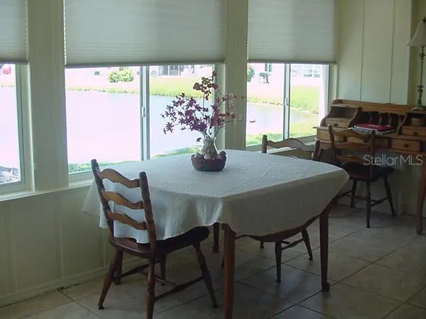 a view of a dining room with furniture a large window and outside view