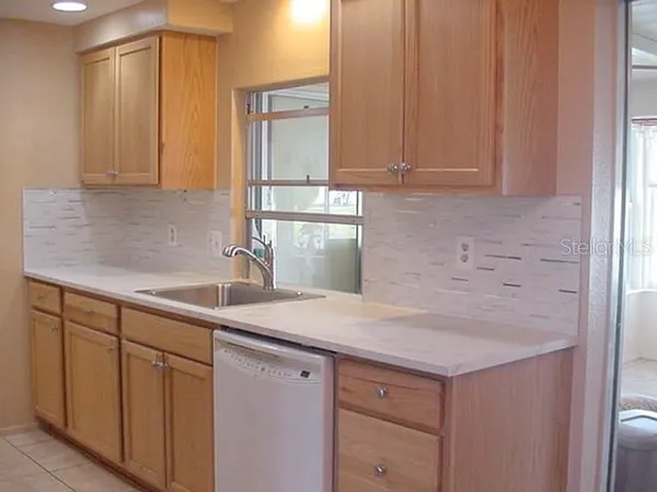 a kitchen with stainless steel appliances granite countertop a sink and cabinets