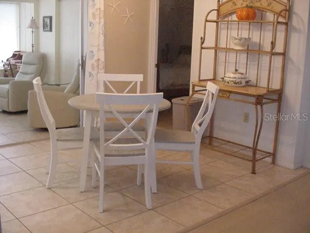 a view of a dining room with furniture and window
