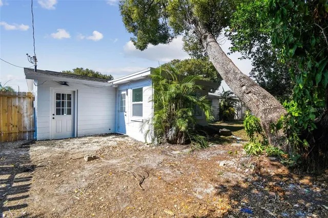 a view of a house with a yard and sitting area