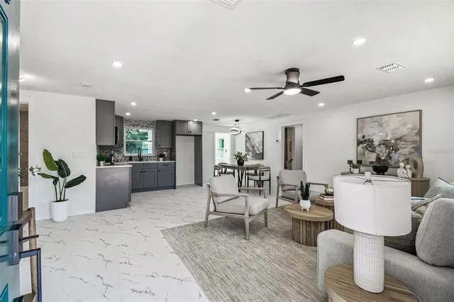 a living room with furniture and kitchen view