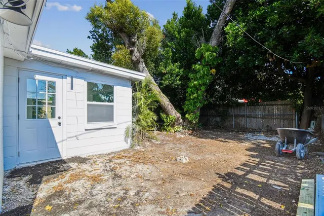 a view of a house with backyard and sitting area