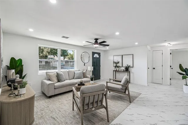 a living room with furniture and a large window