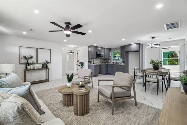 a living room with furniture or kitchen view and a dining table