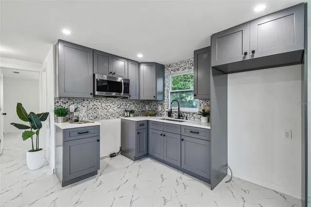 a kitchen with a sink cabinets and stainless steel appliances