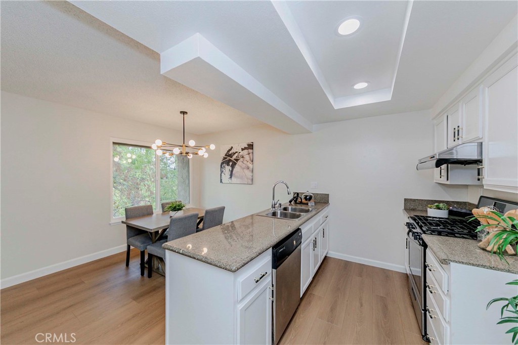 1525 Walnut Leaf Drive, Unit 211 Walnut, CA 91789 - Photo 11 of 26 a kitchen that has a table and chairs in it