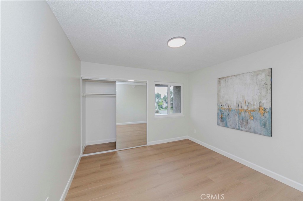 1525 Walnut Leaf Drive, Unit 211 Walnut, CA 91789 - Photo 17 of 26 an empty room with a painting on the wall