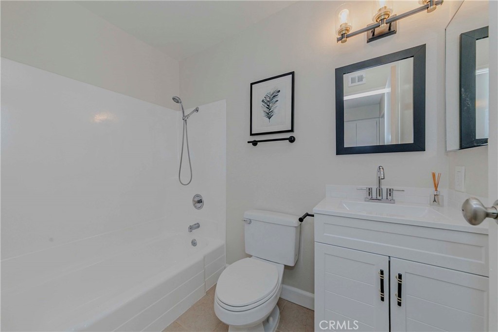 1525 Walnut Leaf Drive, Unit 211 Walnut, CA 91789 - Photo 19 of 26 a bathroom with a toilet sink vanity granite and shower