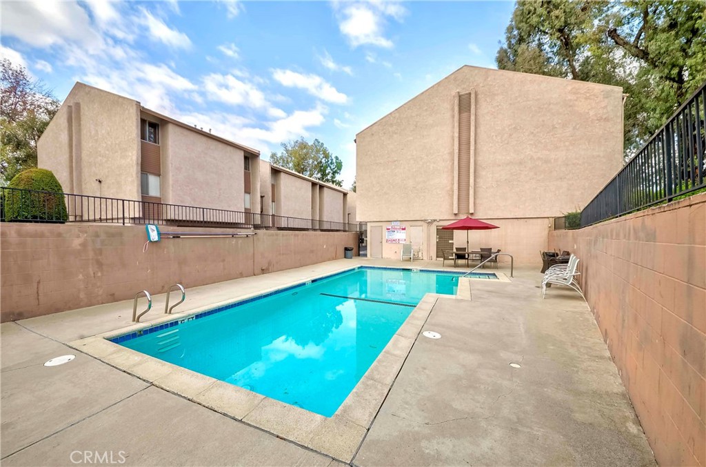 1525 Walnut Leaf Drive, Unit 211 Walnut, CA 91789 - Photo 23 of 26 a view of swimming pool with a patio