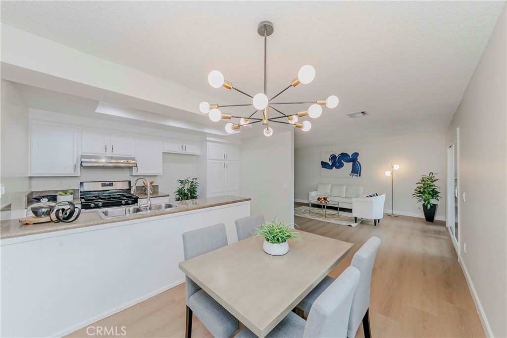 1525 Walnut Leaf Drive, Unit 211 Walnut, CA 91789 - Photo 3 of 26 a kitchen with a table a sink and cabinets