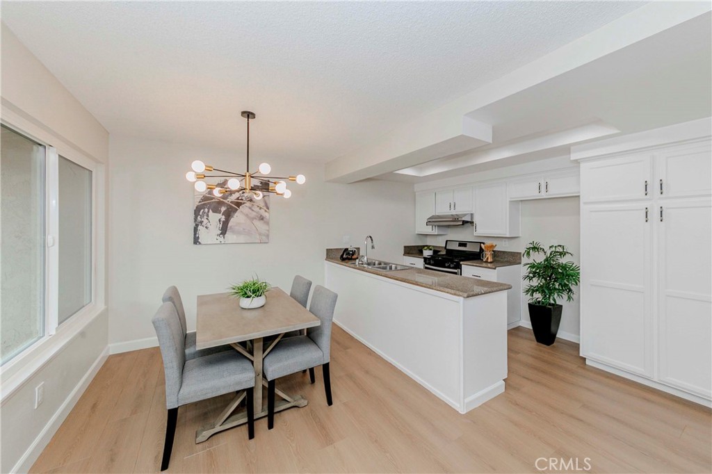 1525 Walnut Leaf Drive, Unit 211 Walnut, CA 91789 - Photo 7 of 26 a kitchen with a refrigerator and a dining table