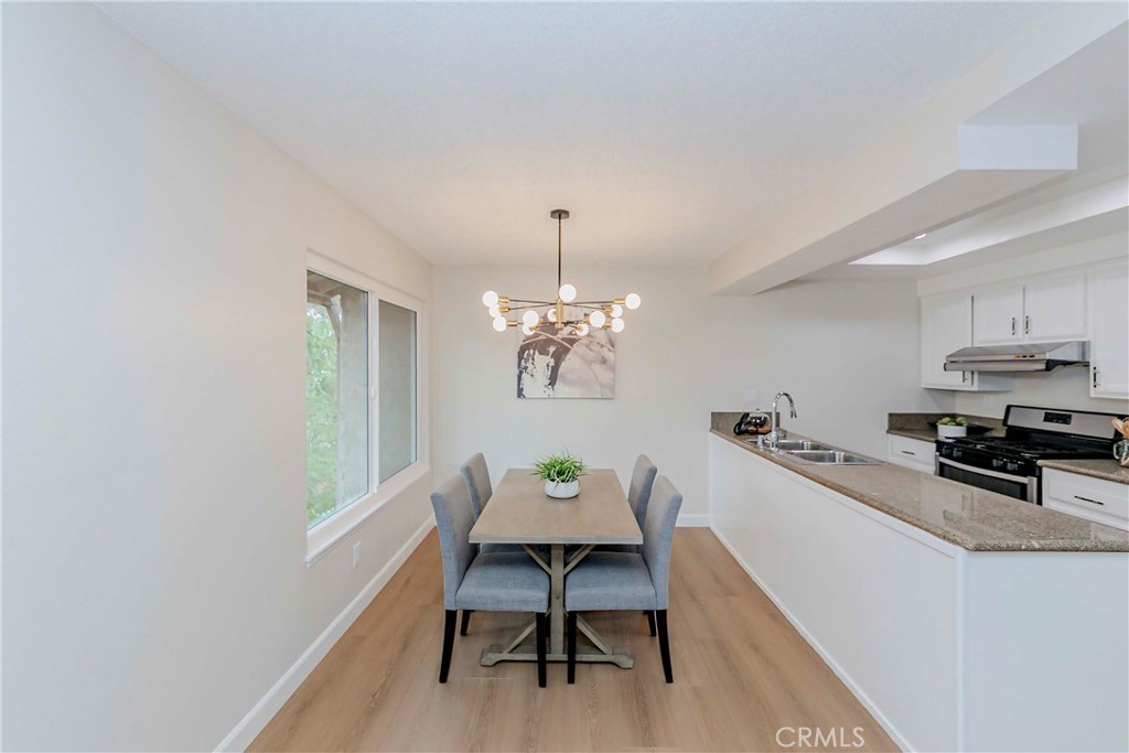 1525 Walnut Leaf Drive, Unit 211 Walnut, CA 91789 - Photo 8 of 26 a view of a dining room with furniture and a chandelier