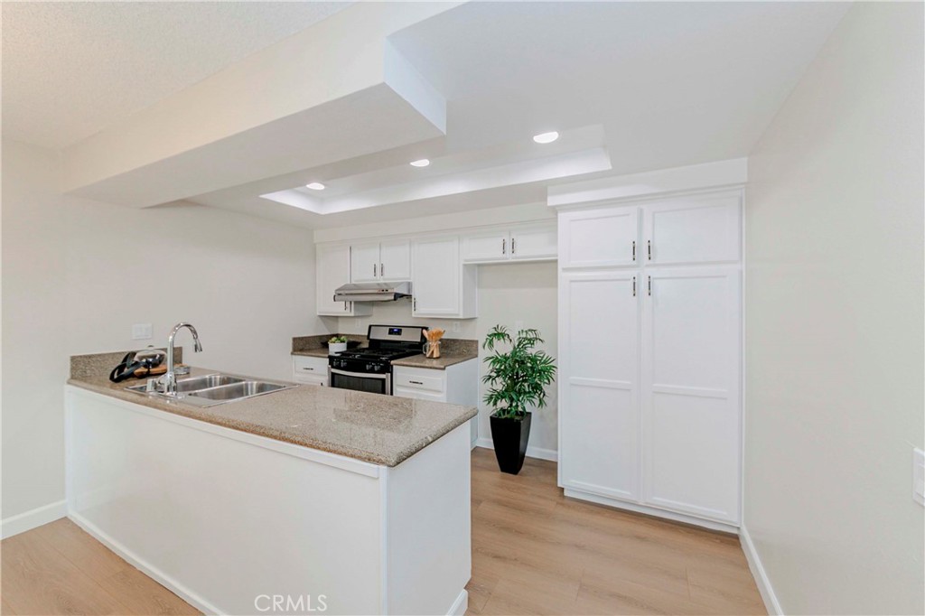 1525 Walnut Leaf Drive, Unit 211 Walnut, CA 91789 - Photo 9 of 26 a kitchen with a sink a refrigerator and a stove