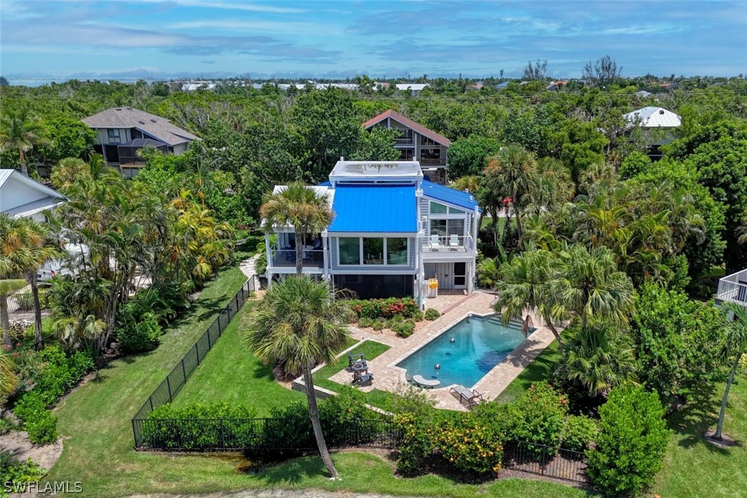 1021 Sand Castle Road Sanibel, FL 33957 - Photo 1 of 49 an aerial view of a house with a yard