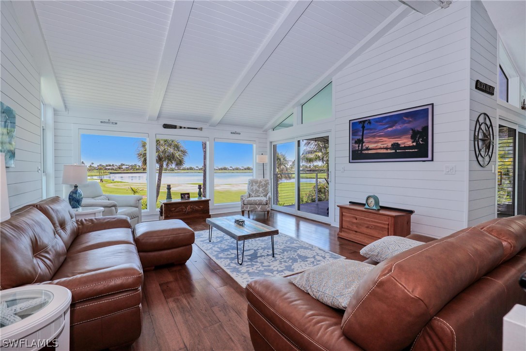 1021 Sand Castle Road Sanibel, FL 33957 - Photo 14 of 49 a living room with furniture a rug and a wall painting
