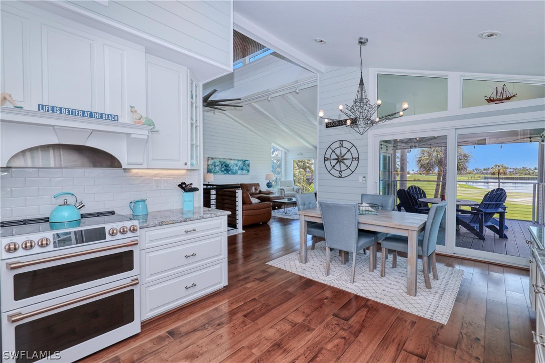 1021 Sand Castle Road Sanibel, FL 33957 - Photo 18 of 49 a view of kitchen and dining room with wooden floor