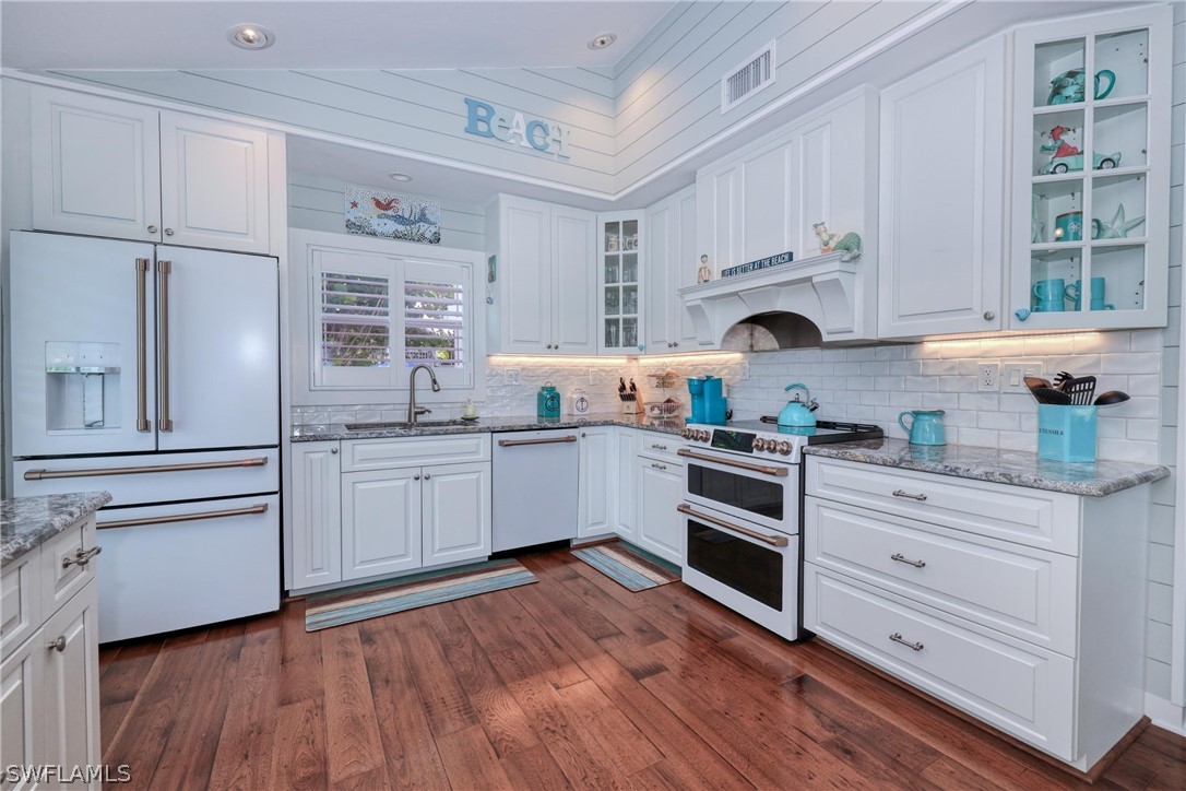 1021 Sand Castle Road Sanibel, FL 33957 - Photo 21 of 49 a kitchen with cabinets wooden floor and a sink