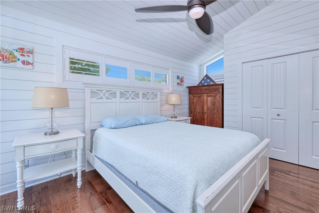 1021 Sand Castle Road Sanibel, FL 33957 - Photo 27 of 49 a bedroom with a bed and a lamp on table