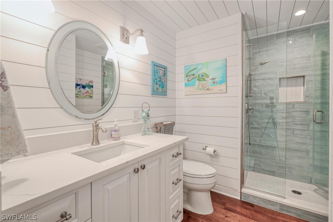 1021 Sand Castle Road Sanibel, FL 33957 - Photo 29 of 49 a bathroom with a toilet a sink and mirror