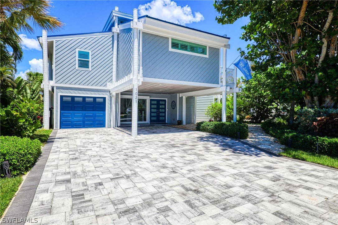 1021 Sand Castle Road Sanibel, FL 33957 - Photo 3 of 49 a front view of a house with a yard