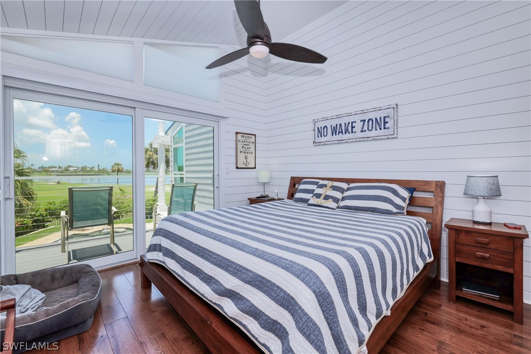 1021 Sand Castle Road Sanibel, FL 33957 - Photo 32 of 49 a bedroom with a bed and a large window