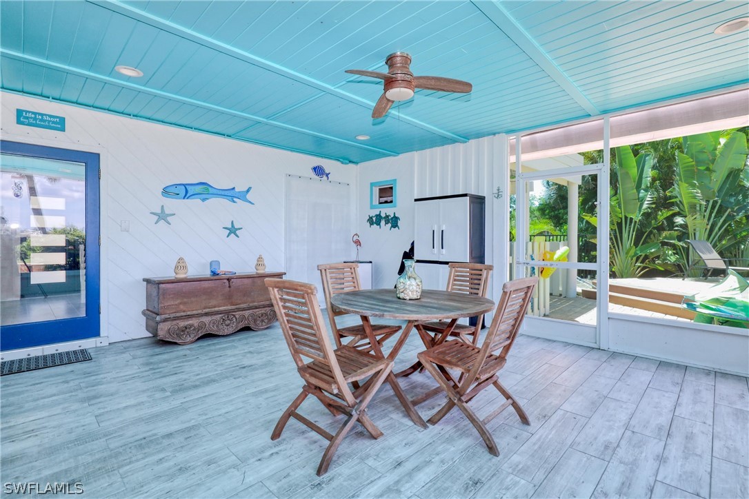 1021 Sand Castle Road Sanibel, FL 33957 - Photo 41 of 49 a view of a dining room with furniture window and wooden floor