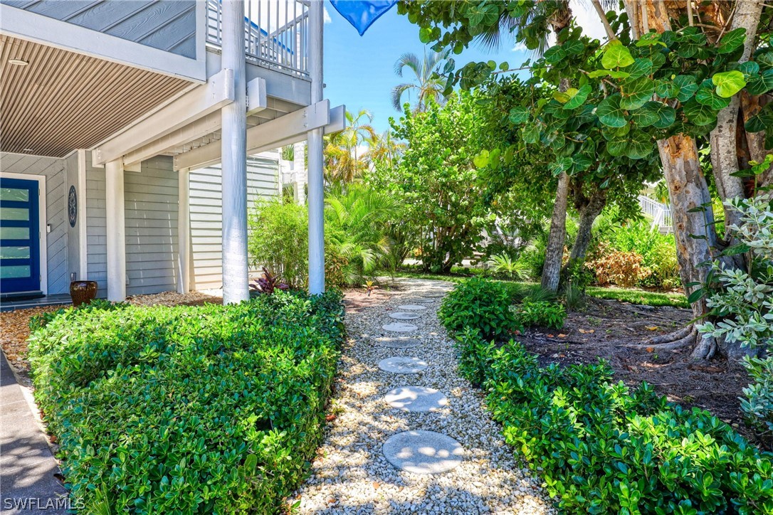 1021 Sand Castle Road Sanibel, FL 33957 - Photo 6 of 49 a view of a pathway both side of house