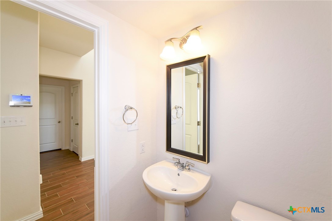 2069 Flametree Avenue New Braunfels, TX 78132 - Photo 13 of 46 a bathroom with a sink and a mirror