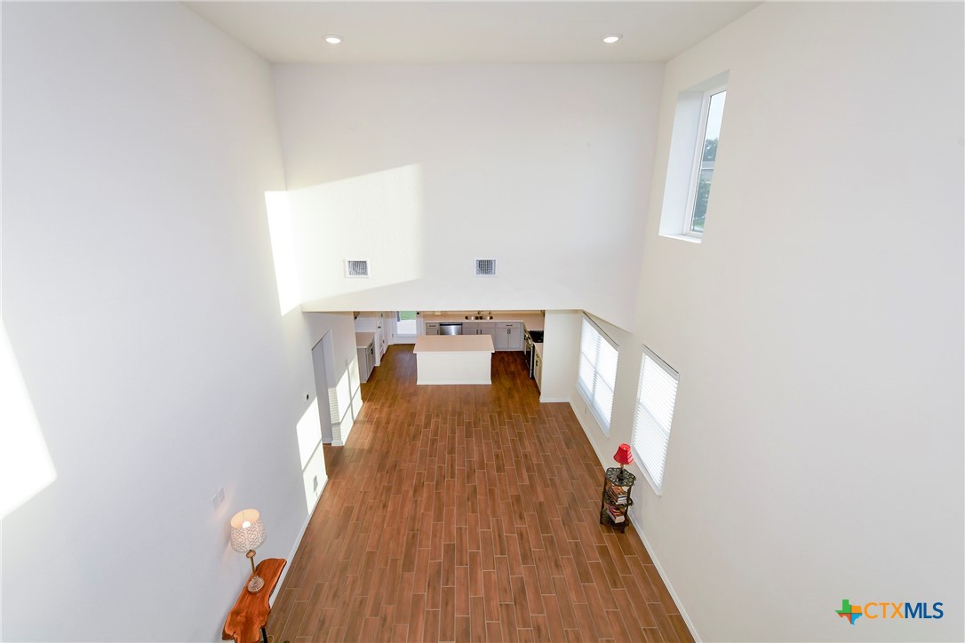 2069 Flametree Avenue New Braunfels, TX 78132 - Photo 14 of 46 a view of a hallway with wooden floor