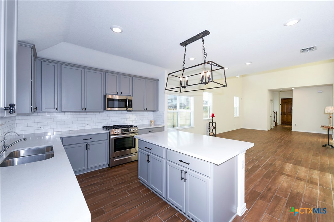 2069 Flametree Avenue New Braunfels, TX 78132 - Photo 19 of 46 a kitchen with cabinets a sink and appliances