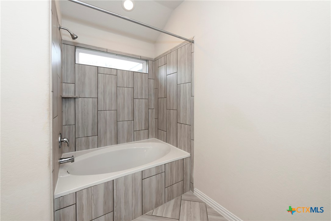 2069 Flametree Avenue New Braunfels, TX 78132 - Photo 24 of 46 a bathroom with a bathtub and shower