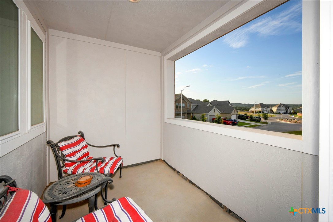 2069 Flametree Avenue New Braunfels, TX 78132 - Photo 28 of 46 a living room with a couch and a potted plant on the wall