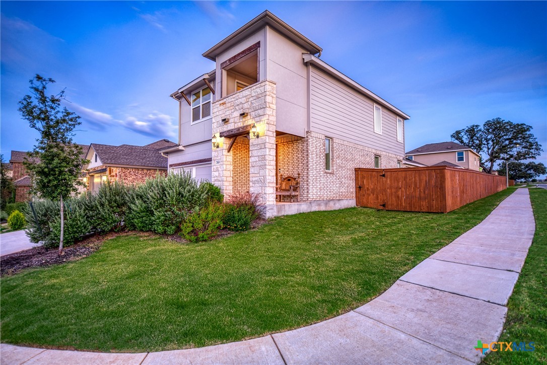 2069 Flametree Avenue New Braunfels, TX 78132 - Photo 4 of 46 a front view of a house with garden