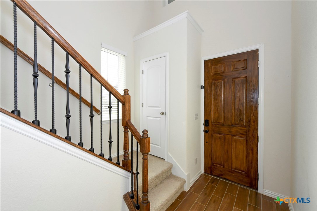 2069 Flametree Avenue New Braunfels, TX 78132 - Photo 6 of 46 a view of an entryway with wooden floor