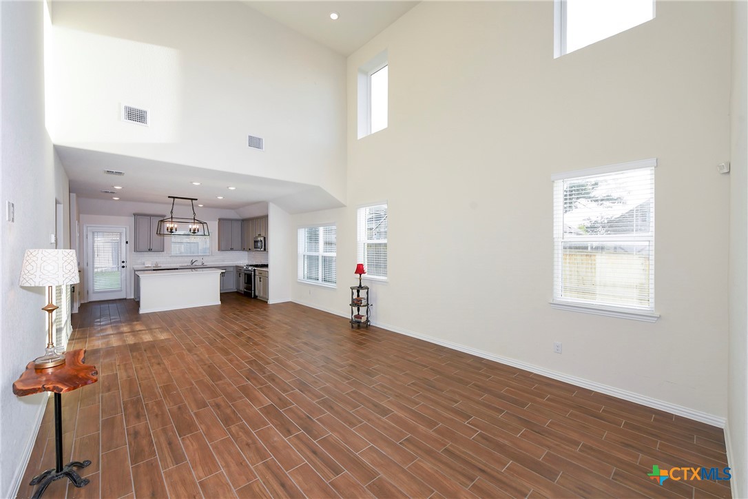 2069 Flametree Avenue New Braunfels, TX 78132 - Photo 9 of 46 a view of kitchen and hall with wooden floor