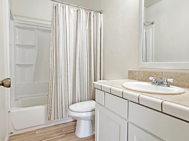a bathroom with a sink toilet and shower