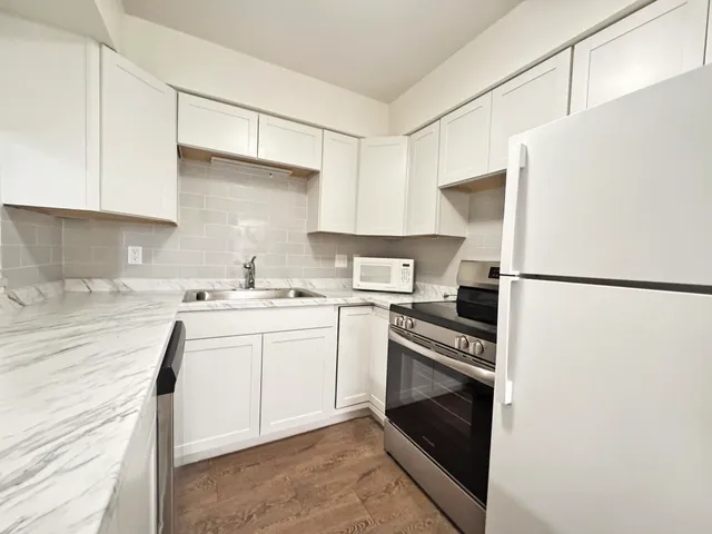 a kitchen with a sink a stove and refrigerator