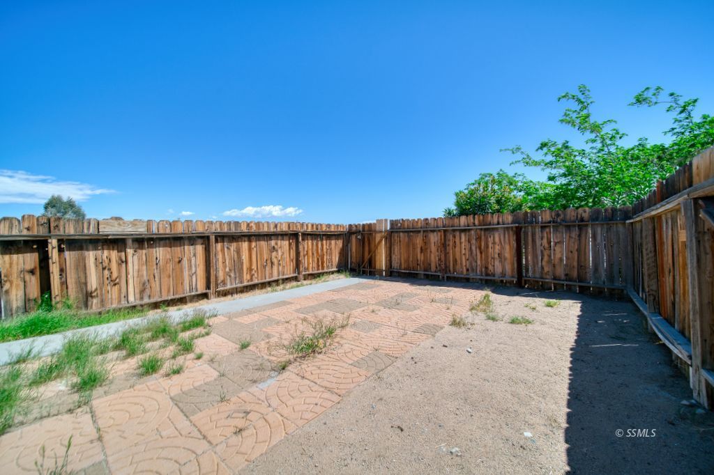 137 South Richmond Road Ridgecrest, CA 93555 - Photo 31 of 31 a backyard of a house with wooden fence