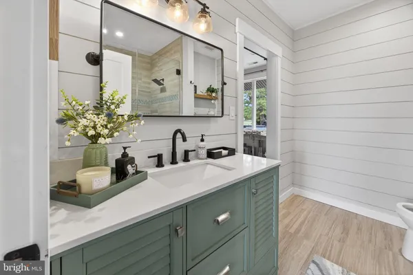 a bathroom with a toilet a sink and mirror
