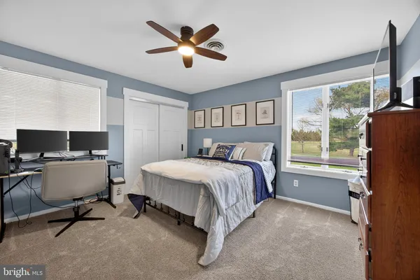 a living room with furniture and floor to ceiling window