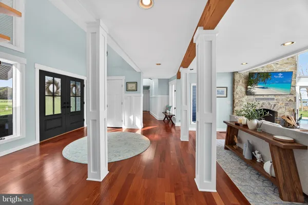 a living room with furniture fireplace and a large window