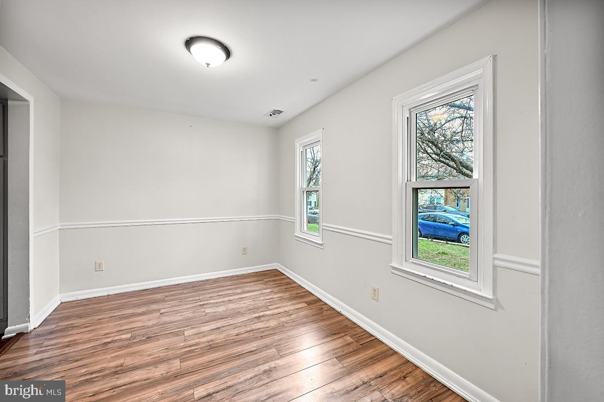 124 Marlow Street Southwest Leesburg, VA 20175 - Photo 12 of 37 a view of an empty room with wooden floor and a window